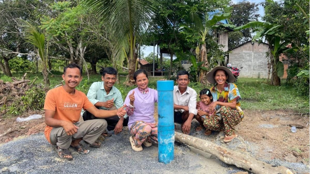 Villagers beside a newly drilled well, paid for with the fair trade premium